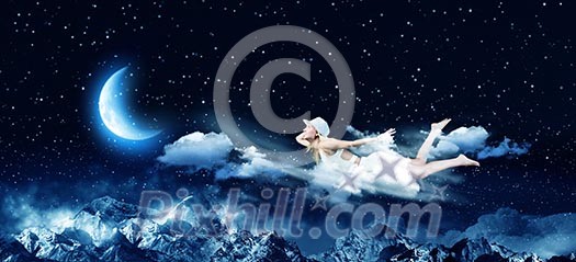 Young blond girl flying in night sky