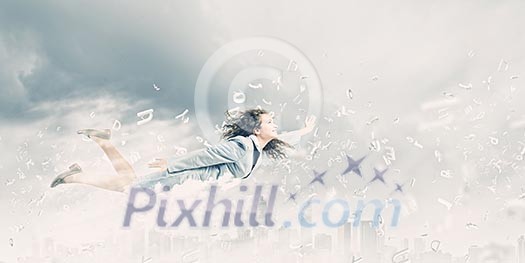 Young pretty businesswoman flying in blue sky Young pretty businesswoman flying in blue sky