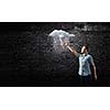 Young man touching illustration of raining cloud