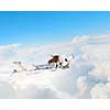 Young pretty businesswoman flying in blue sky