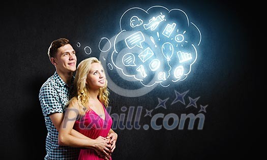 Conceptual image of young couple hugging each other and dreaming Conceptual image of young couple hugging each other and dreaming