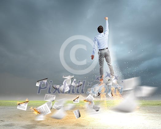 Rear view of businessman superhero flying up in sky