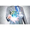 Close up of businessman holding Earth planet in palms. Elements of this image are furnished by NASA
