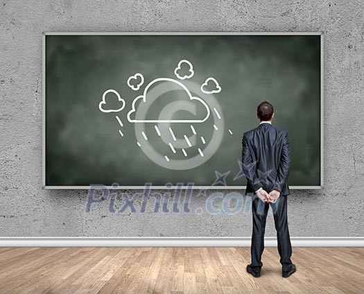 Rear view of businessman looking at chalkboard Rear view of businessman looking at chalkboard