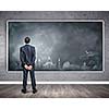Rear view of businessman looking at chalkboard