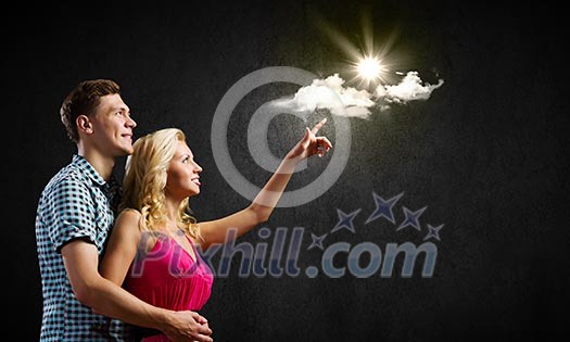 Conceptual image of young couple hugging each other and dreaming Conceptual image of young couple hugging each other and dreaming