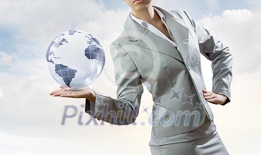 Young businesswoman holding Earth planet in palm