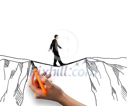 Brave businessman walking on rope above mountain gap