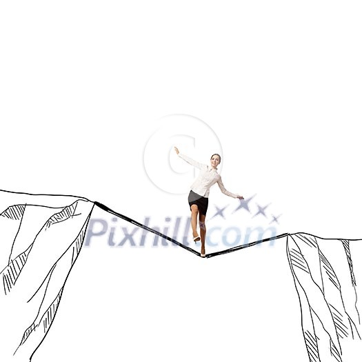 Young businesswoman walking on rope above mountain gap Young businesswoman walking on rope above mountain gap