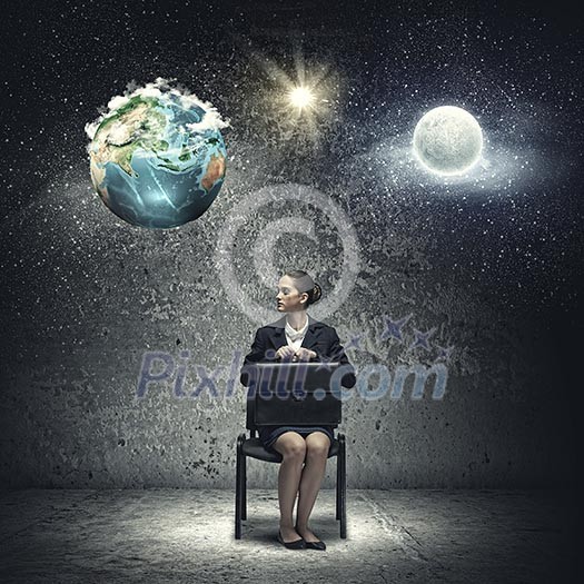 Young upset businesswoman with suitcase sitting on chair. Elements of this image are furnished by NASA