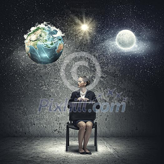 Young upset businesswoman with suitcase sitting on chair. Elements of this image are furnished by NASA Young upset businesswoman with suitcase sitting on chair. Elements of this image are furnished by NASA
