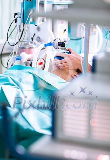Anesthesia - patient under narcosis, breathing through a mask during surgery Anesthesia - patient under narcosis, breathing through a mask during surgery