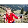 Pretty, young female hiker having a tough walk uphill