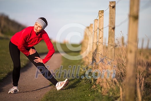 Young woman on her evening jog along the seacoast Young woman on her evening jog along the seacoast
