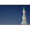 White mosque with minaret against blue sky (Sur, Oman)