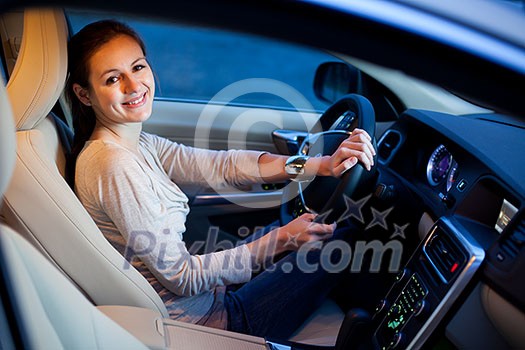 Pretty young woman driving her new car Pretty young woman driving her new car