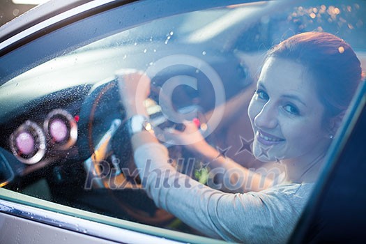 Pretty young woman driving her new car Pretty young woman driving her new car