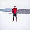 Cross-country skiing: young man cross-country skiing on a lovely snowy winter day