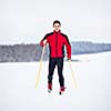 Cross-country skiing: young man cross-country skiing on a lovely snowy winter day