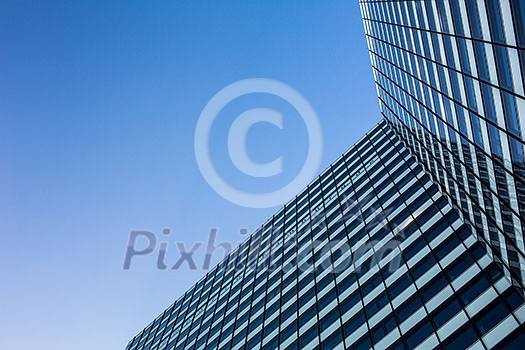 Exterior of building - abstract concept; skyscraper from down below against blue sky