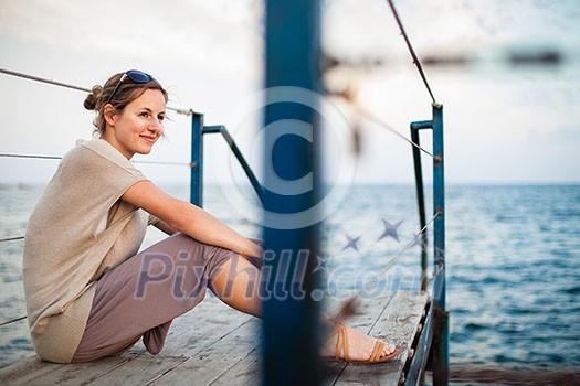 Portrait of a young woman at the seacoast while on vacation Portrait of a young woman at the seacoast while on vacation