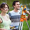 Two young land surveyors at work