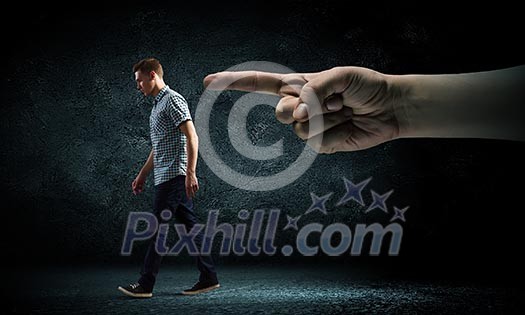 Funny image of young man and huge hand