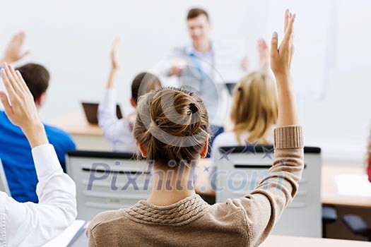 Young teacher in classroom standing in front of class Young teacher in classroom standing in front of class