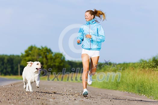 Young healthy girl running outdoor with her dog