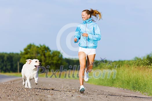 Young healthy girl running outdoor with her dog Young healthy girl running outdoor with her dog