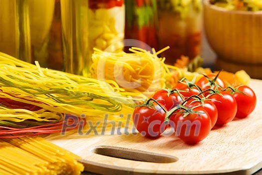Cherry tomatoes and vegetables on kitchen table Cherry tomatoes and vegetables on kitchen table