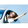 Young pretty woman driving car and leaning out of car window