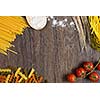 Cherry tomatoes and vegetables on kitchen table