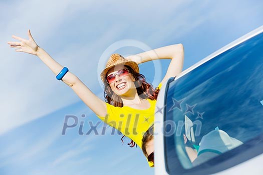 Young pretty woman leaning out of car window Young pretty woman leaning out of car window