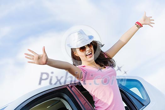 Young pretty woman leaning out of car window Young pretty woman leaning out of car window