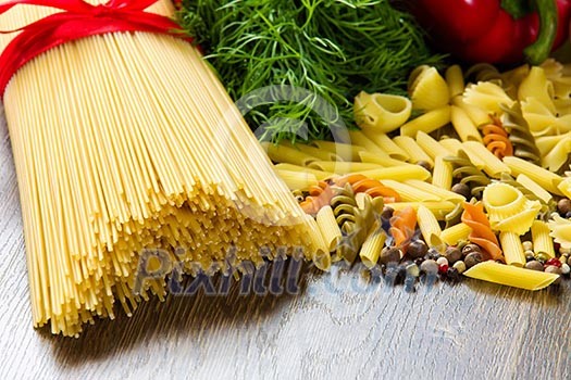 Close up of macaroni and other ingredients on kitchen table Close up of macaroni and other ingredients on kitchen table