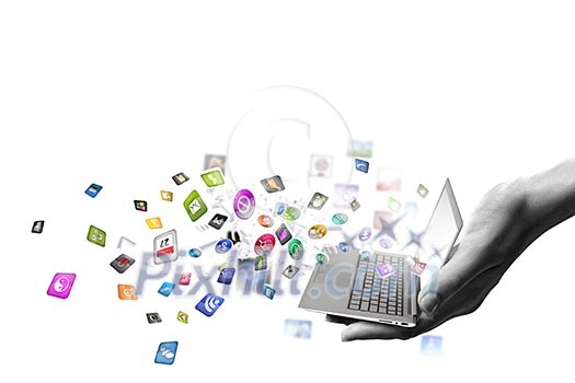 Close up of hand with laptop and media icons Close up of hand with laptop and media icons