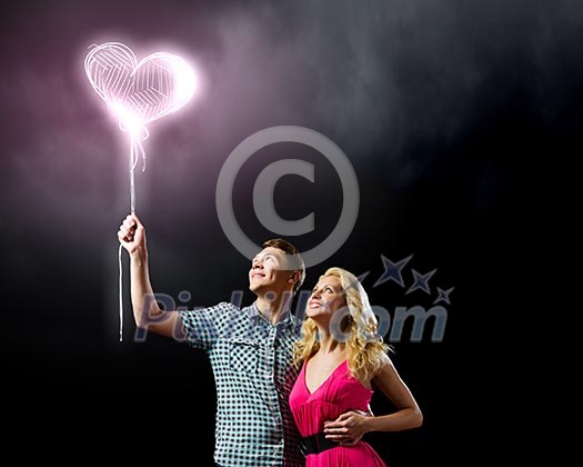 Conceptual image of young couple hugging each other and dreaming