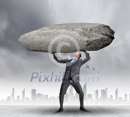 Powerful businessman holding huge stone above head Powerful businessman holding huge stone above head
