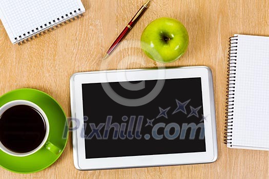 Tablet pc cup of coffee and notepad at table Tablet pc cup of coffee and notepad at table