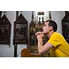 Handsome young man praying in a church