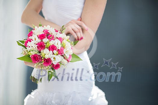 Beautiful wedding bouquet in hands of the bride