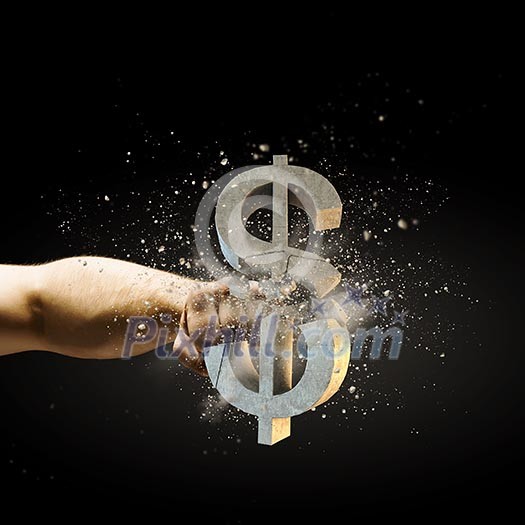 Close up image of human hand breaking dollar stone symbol Close up image of human hand breaking dollar stone symbol