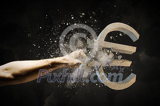 Close up image of human hand breaking euro stone symbol