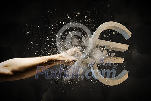 Close up image of human hand breaking euro stone symbol Close up image of human hand breaking euro stone symbol