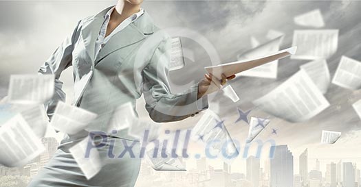 Businesswoman in suit holding documents in hands. Paperwork Businesswoman in suit holding documents in hands. Paperwork