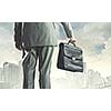 Back view of businessman with suitcase walking on road
