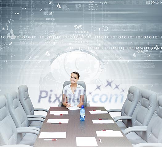 Young attractive businesswoman sitting at head of negotiating table