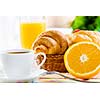 Croissants and cup of coffee on breakfast table