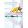 Pretty young woman doing YOGA exercise at home